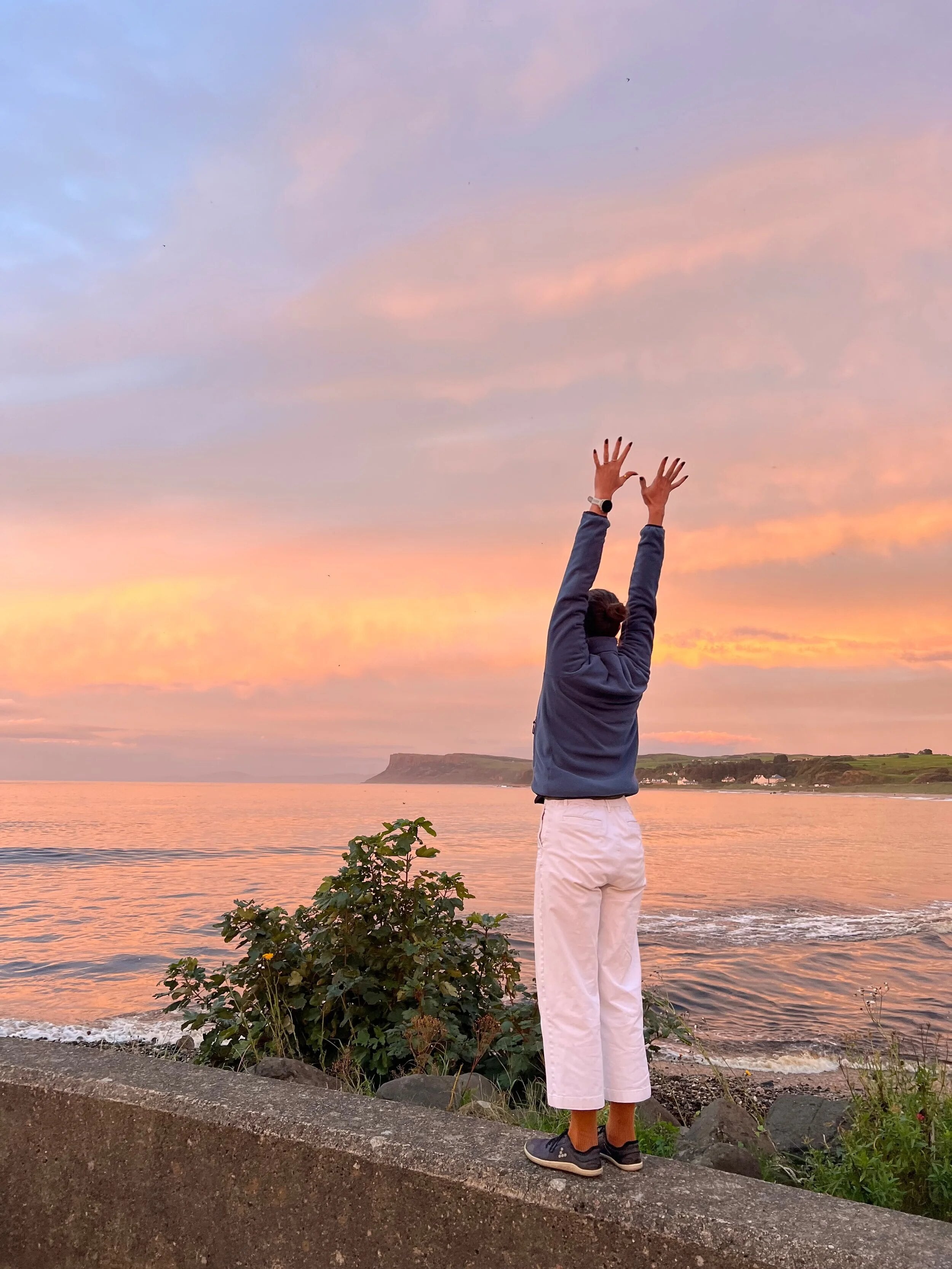 Stretching towards a sunset over the sea