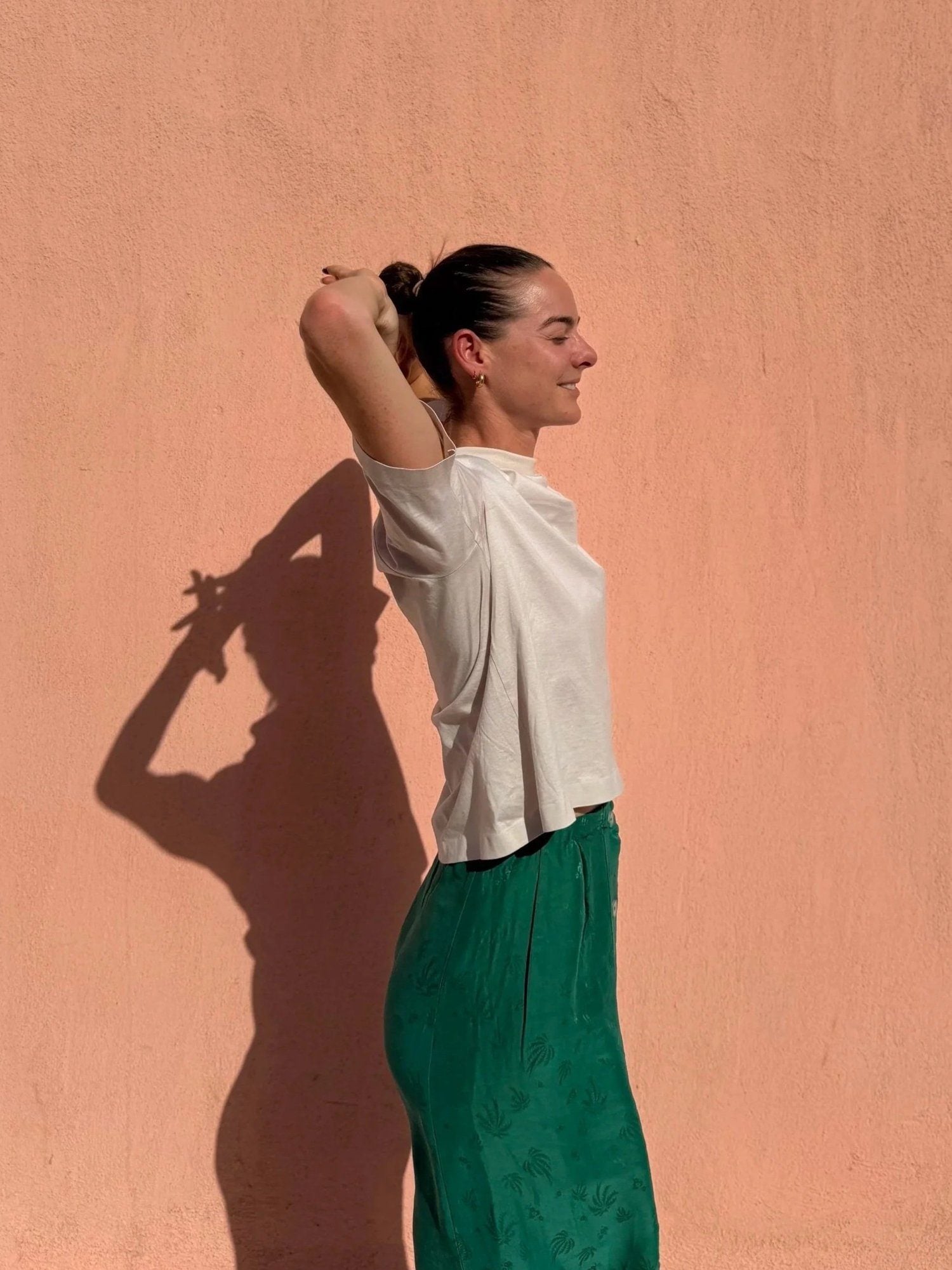 Zael against a warm wall in sunlight